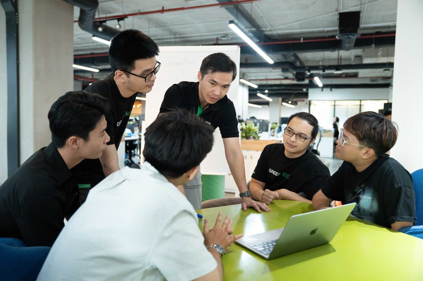 VNG engineers working together around a laptop